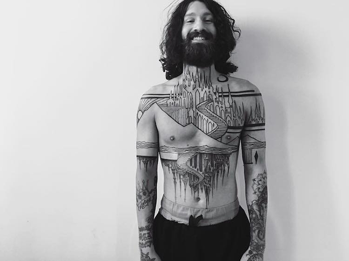 Hombre con tatuaje arquitectura gótica en el cuerpo